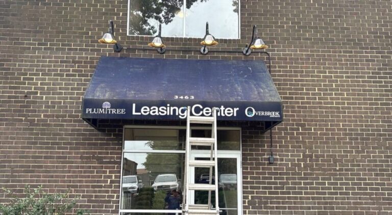 Leasing center awning before cleaning in Ellicott City, Maryland.