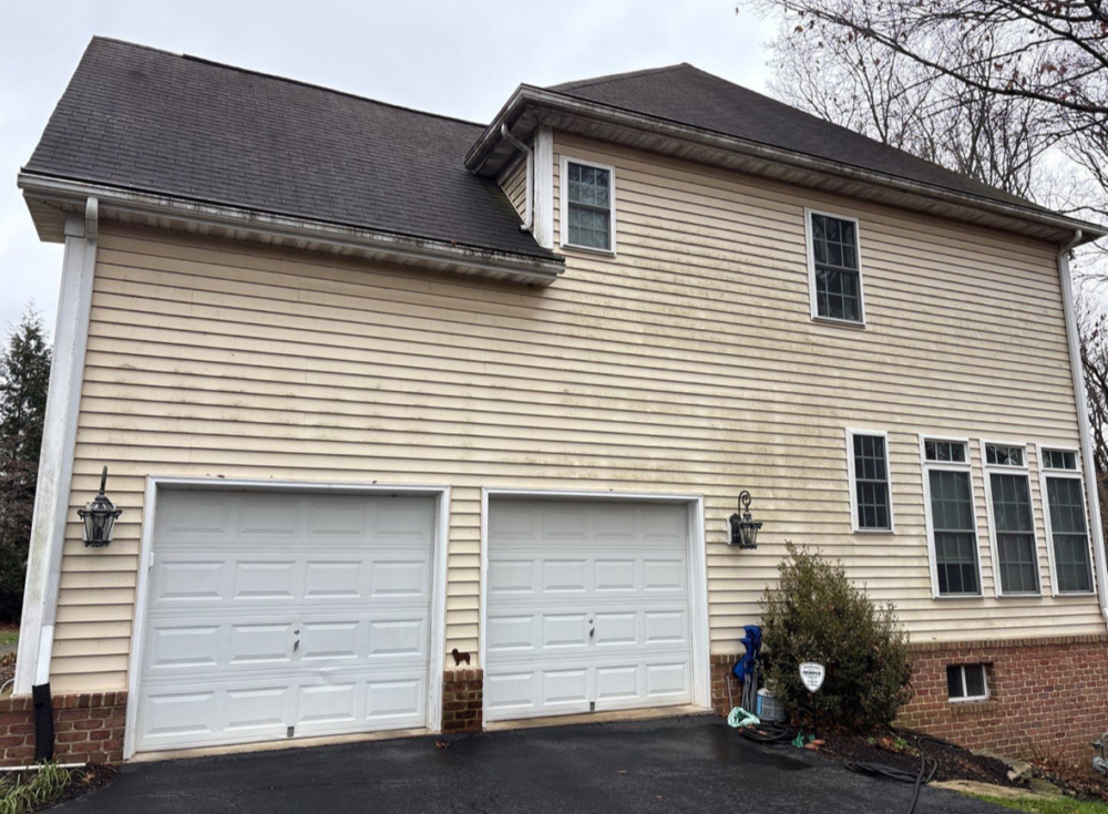 Vinyl siding above the garage before soft washing in Glenwood, Maryland