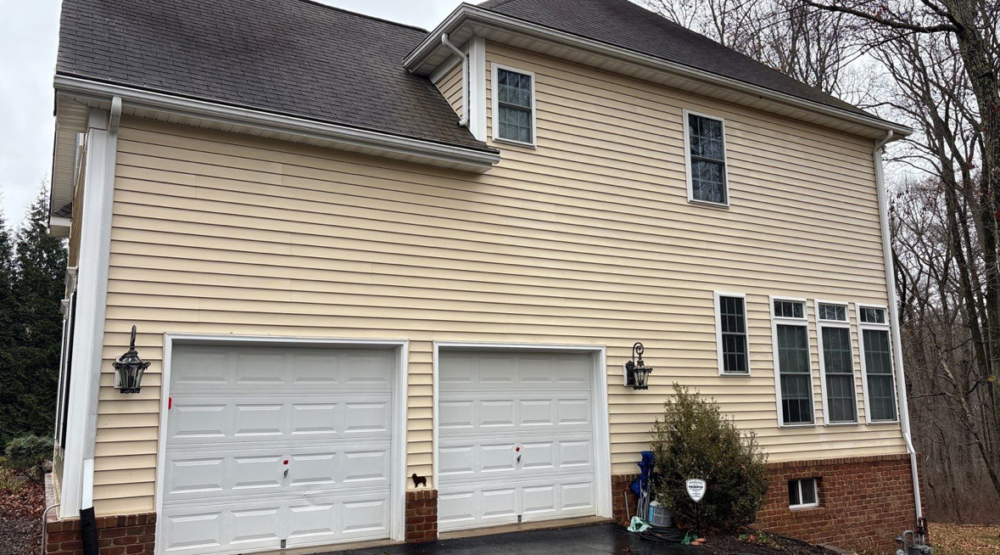 The same vinyl siding above the garage after soft washing in Glenwood, Maryland