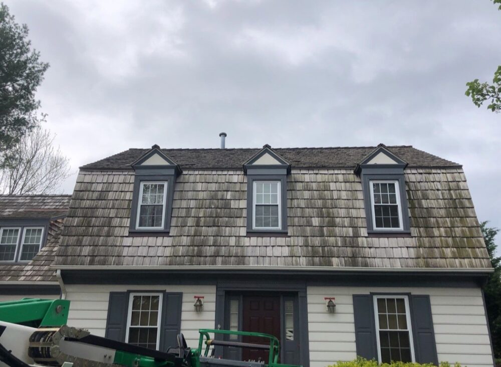 Cedar shake roof with dark streaking before soft washing in Gaithersburg.